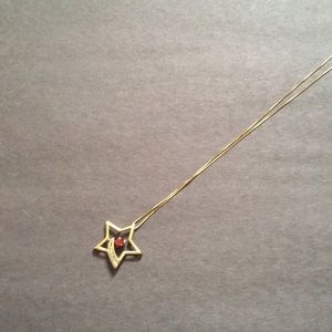 Gold Star Necklace with Red Gemstone